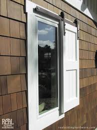 They reduce storm damage to a home by preventing projectiles from breaking glass and damaging doors. Sliding Hardware Is Used To Create An Exterior Shutter Exterior Barn Doors Shutters Exterior House Shutters