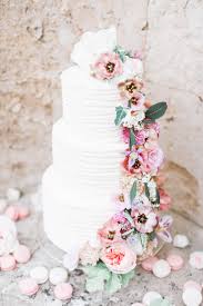 a wedding cake with fresh flowers