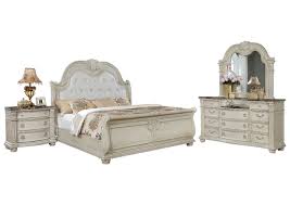 The basic bedroom set includes a bed frame, a nightstand, and a dresser or chest. Stanley Antique White King Bedroom Set Ivan Smith