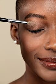 makeup artist applying eye shadow