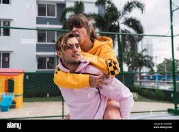 Young Woman licking boyfriends head giving piggyback ride while spending  time on sports ground together Stock Photo - Alamy