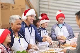 multi ethnic volunteers serves food at