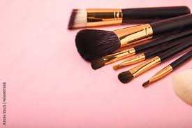 cosmetic makeup brush on a pink