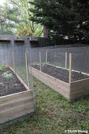 Hammer two bamboo canes about five feet apart and one to two feet into the ground along the boundary line. How To Build A Diy Raised Garden Bed And Protect It With A Metal Fence