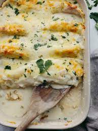 A Pan Full Of White Chicken Enchiladas Topped With Cheese White  gambar png