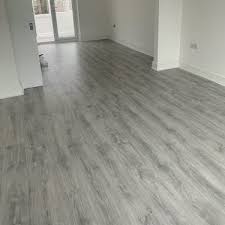 Dark grey laminate flooring in bedroom with white bedding. Free Grey Laminate Flooring Samples Discount Flooring Depot