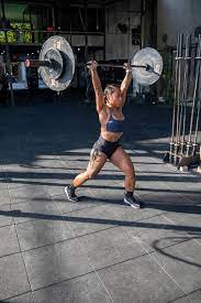 muscular female athlete lifting heavy
