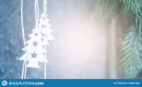 Two Small White Christmas Trees Hanging On The Background Of