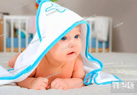 cute baby boy in a hooded towel after