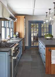 blue kitchen cabinets with gray floor