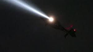 helicopter with spotlight keeping an