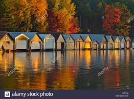 Boat Houses Reflected In The Waters Of Penage Panache Lake