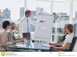 Manager Pointing At The Peak Of A Chart During A Meeting