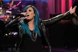She does need to stop dying her hair so much. Demi Lovato Debuts Blue Hair Neon Lights On Leno