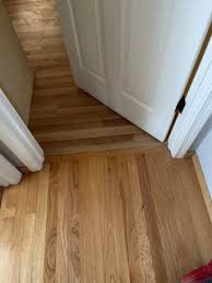 laying hardwood in hallway and into