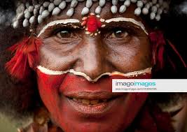 papuan woman with red tribal makeup on