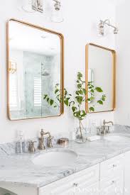 Cabinets are pure white, light fixtures are black/champagne, cabinet pulls are champagne, appliances are cafe matte white with brushed bronze. 3 Mixed Metal Bathroom Design Combinations Maison De Pax
