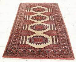 an antique handmade used bukhari carpet