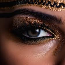 gold glitter eyes and a gold eye make