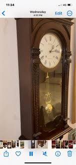 Rhythm Brown Wood Pendulum Wall Clock