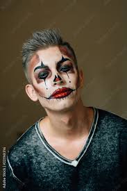 handsome guy with a clown makeup on his