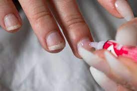 how to remove nail glue from clothing