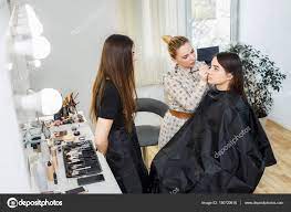 makeup teacher with student stock photo