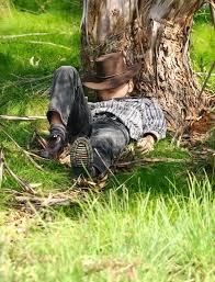 Silhouette of cowboy on horse. A Child Sleeps Under A Gum Tree In A Stock Image Colourbox