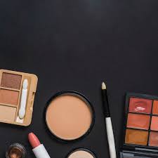 makeup kit on black backdrop