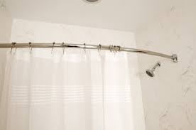 a shower curtain rod up on tile walls