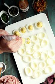 any way you get the yolk mixture into the egg whites is the right way spooning the mixture in is quite effective using a pastry bag with a large round tip