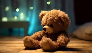 cute teddy bear sitting on the floor a