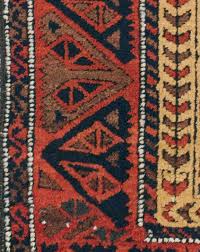 antique baluch rug in a camel field