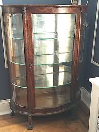 vintage curio cabinet with curved glass