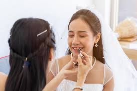 woman artist is makeup for asian brides