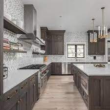 Ahead are 30 examples of two tone kitchen cabinets that make a strong case for abandoning uniformity. White And Gray Marble Herringbone Tiles With Dark Brown Cabinets Brown Kitchen Cabinets Marble Floor Kitchen Brown Cabinets