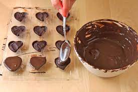 Using a spatula, run the chocolate off the molds. How To Make Molded Chocolate Candies