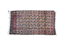 a turkmen prayer rug with repeating