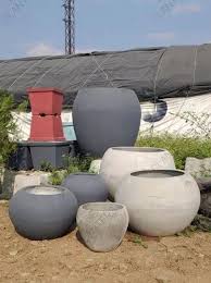 gray round cement flower pot for