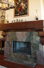Simple wood mantel resting inside of stone. The Slate Stone Fireplace Veritably Versatile Freestanding Fireplace Slate Fireplace Brick Fireplace Makeover