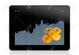 Gold Bitcoin And A Tablet With Charts Of Crypto Currency