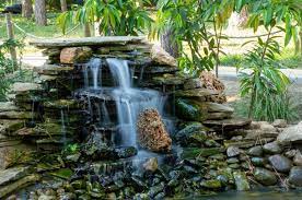 Artificial Waterfall In A Pond In The Park