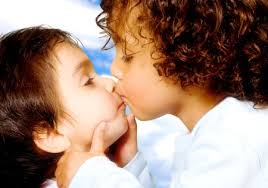 cute baby brothers kissing over a blue