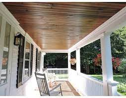 white house and porch with wood ceiling