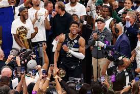 Giannis kisses the nba finals trophy and tells his finals mvp trophy to not get jealous. Si373kwyo9c2lm