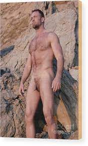 Naked man with muscles and a hairy body stands in front of rocks. Wood  Print by Gunther Allen - Fine Art America