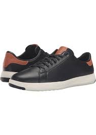 These shoes feature an allover knit fabric upper with lace up design and leather trim. Cole Haan Grandpro Tennis Shoes