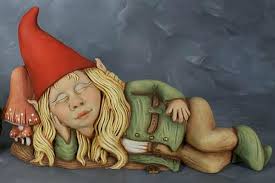Female garden gnome with a red hat and teal coat with gold belt by some lily pad statues. Cute Sleeping Girl Garden Gnome Unpainted Ceramic Statue