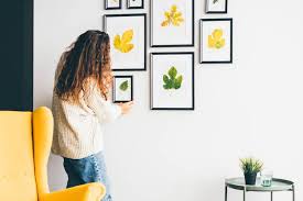 Woman Hanging Picture Frame