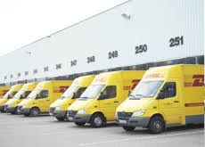 Vans driving for rival couriers fedex and dhl. Dhl Same Day English